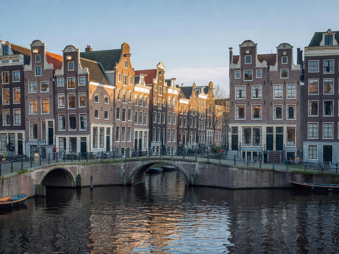 Amsterdam canals with historic Dutch brick architecture and bridges